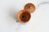 Red Oak Lidded Keepsake Box, Walnut pull, shown with diffuser necklace from Naptime Aromatherapy (not included), Top view, 2" x 2.5"